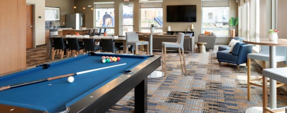 clubhouse with pool table at the liberty apartments and townhomes in golden valley mn