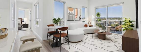 A living room with a white sofa and a coffee table.
