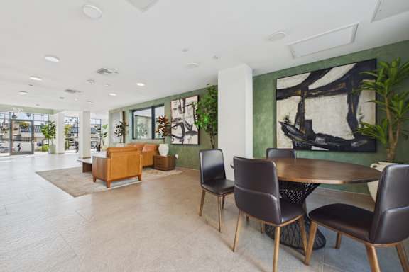 A modern dining room with a table and chairs.