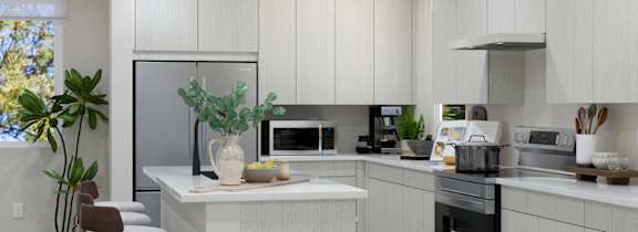 A modern kitchen with white cabinets and a large island.