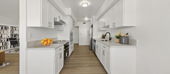 an empty living room with hardwood floors and a balcony