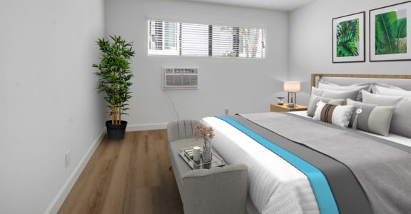a bedroom with white walls and a large bed with a blue blanket