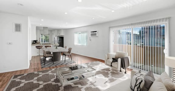 a living room with a white couch and a glass table