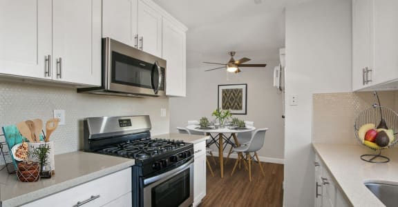 a living room with a kitchen and a dining room