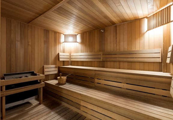 a sauna with wooden benches and a table