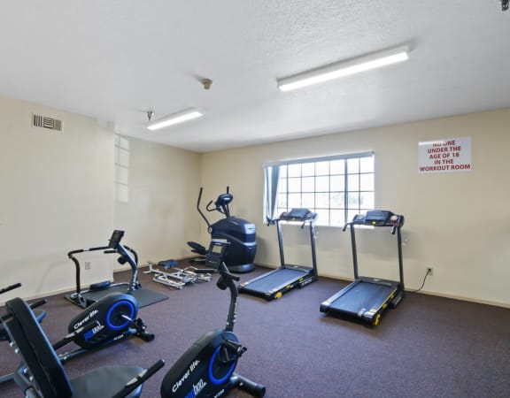 a workout room with exercise equipment at the village
