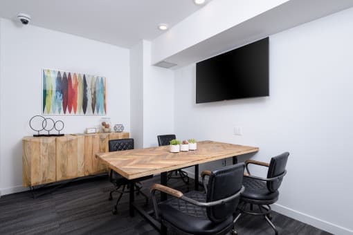 Collaborative workspace with conference table and television