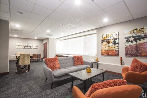 a living room with couches and chairs and a table