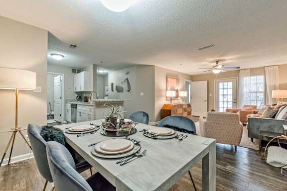 an open living room and dining room with a table and chairs