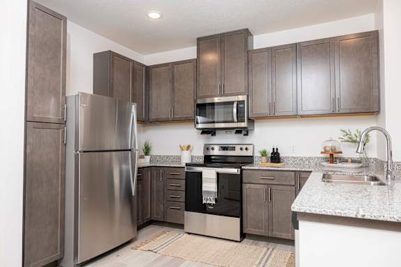 a kitchen with stainless steel appliances and wooden cabinets