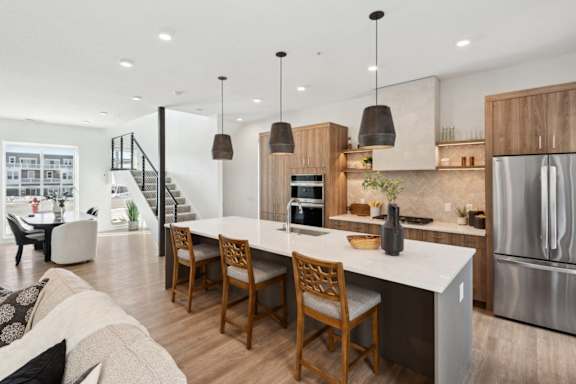 A modern kitchen with a dining table and chairs.