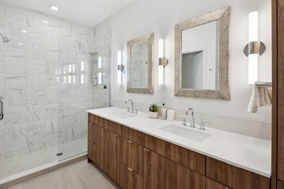 A bathroom with a white sink and a mirror above it.