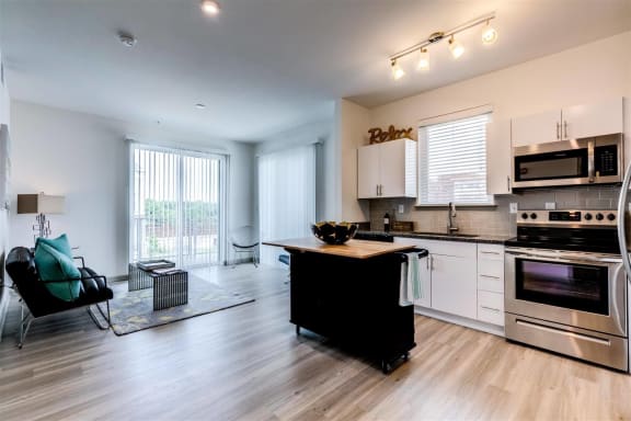 a kitchen with a center island next to a stove top oven at East 51 At Rocketts Landing, Richmond, 23231