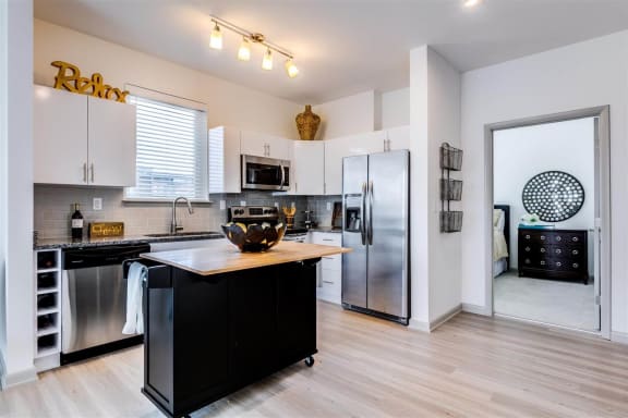 a kitchen with a large island and stainless steel appliances at East 51 At Rocketts Landing, Richmond, 23231