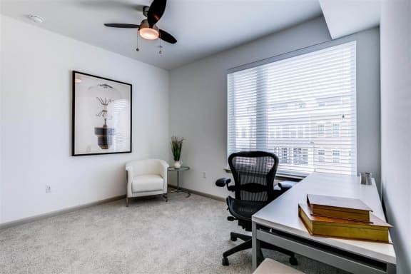 an office with a large window and a ceiling fan at East 51 At Rocketts Landing, Richmond, 23231