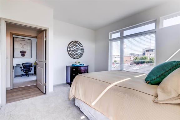 a bedroom with a large bed and a large window at East 51 At Rocketts Landing, Richmond, 23231