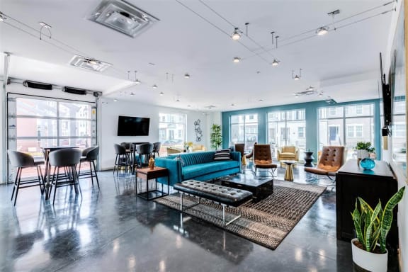a living room with a blue couch and chairs at East 51 At Rocketts Landing, Richmond, 23231