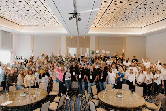 A group of people are gathered in a room for a meeting or event.