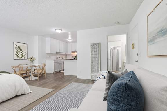 a renovated living room with white walls and wood floors