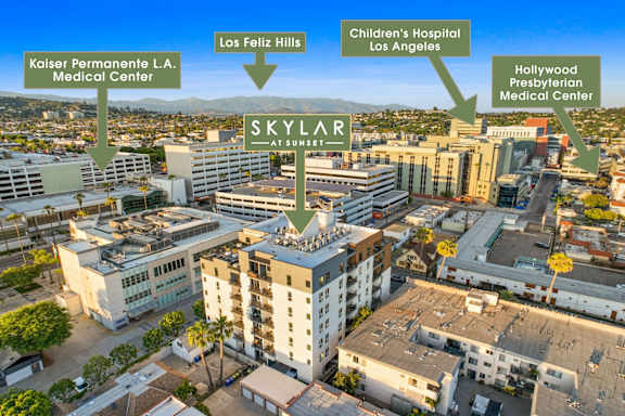An aerial view of a city with a hospital named SKYLAR AT SUNNEY in the center.