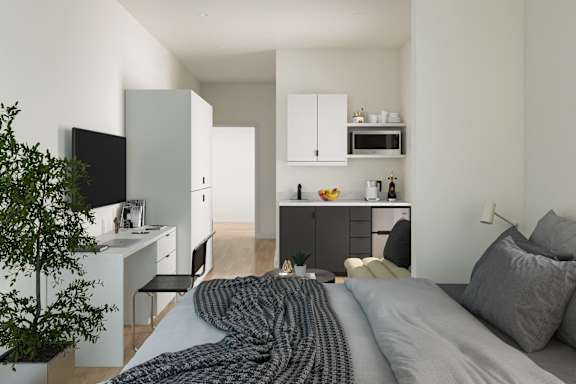 A modern bedroom with a bed, pillows, and a blanket.at Skylar At Sunset, Los Angeles, CA 90027