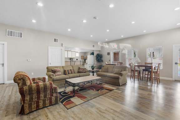 A living room with a sofa, armchair, and coffee table.