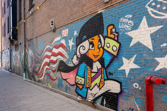 A colorful mural of a penguin dressed as a pirate on a brick wall.