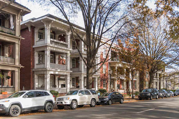 Cars parked on a street in front of a row of houses.at The Collection of Historic Richmond, Richmond