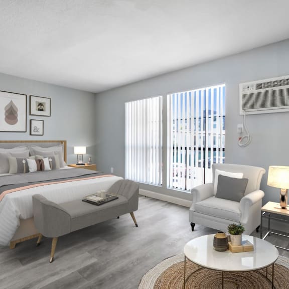 a bedroom with a bed and a chair in a 555 waverly unit