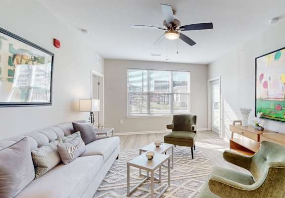a living room with a couch and a ceiling fanat The Slate, Jeffersonville, 47130