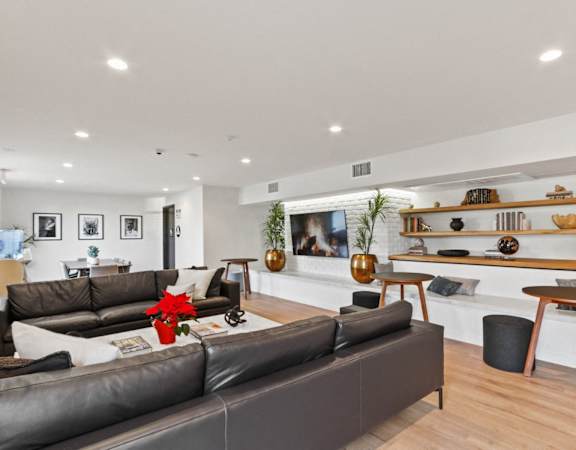 a living room with couches and a table and a fireplace