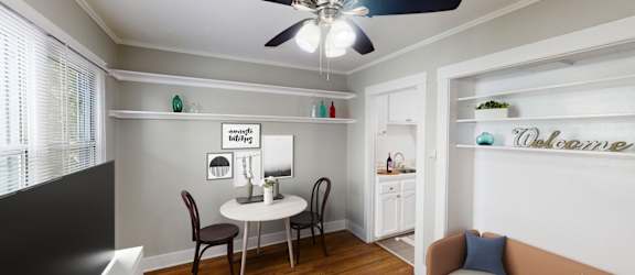 A living room with a dining table and chairs.
