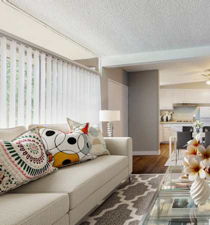 a living room with a couch and a glass table