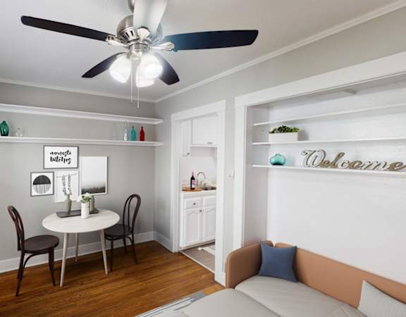 A living room with a dining table and chairs.