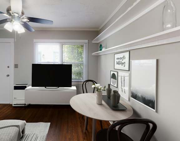 A living room with a white couch and a television.