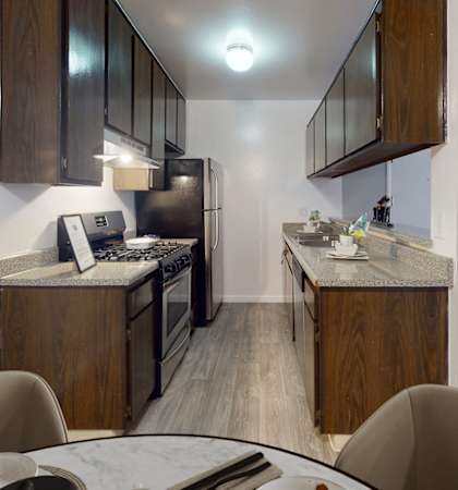 a kitchen and living room with a table and chairs in a home