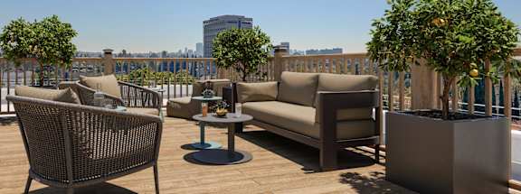 A patio with a chair, a table, and a couch.