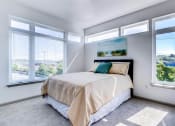 Thumbnail 30 of 35 - a bedroom with a bed and three windows at East 51 At Rocketts Landing, Richmond, 23231