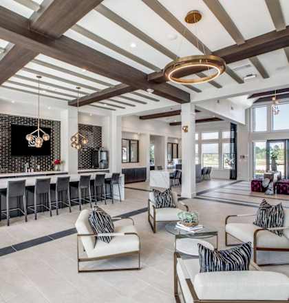 a large living room with furniture and a bar