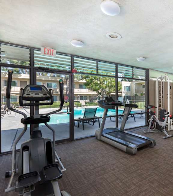 A gym with treadmills, elliptical machines, and other exercise equipment  at Clair Del and Clair Del Gardens, Long Beach, CA