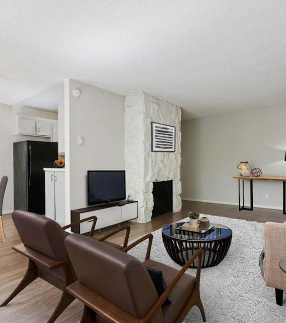 a living room with a couch and a table at Rose Apartments, Los Angeles, CA