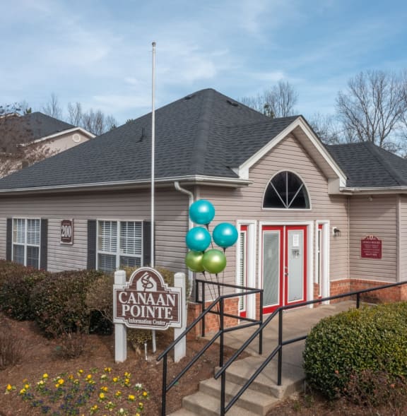 A house with a sign that says Canaan Pointe in front of it.