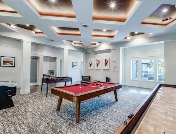 a billiards room with a red pool table