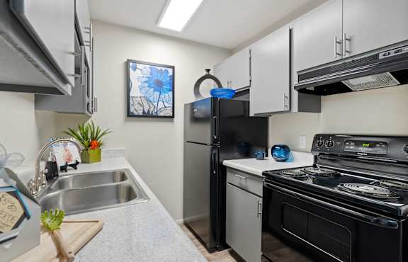 a kitchen with stainless steel appliances and a stove and refrigerator