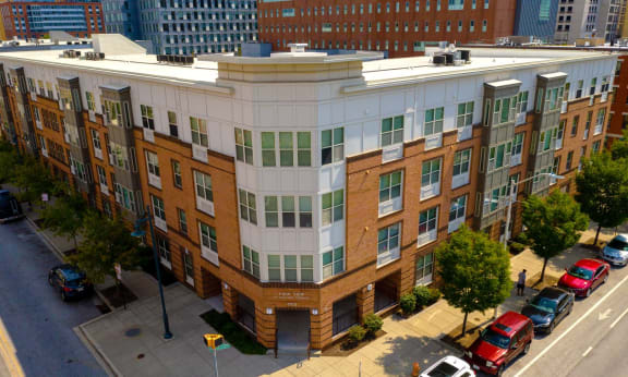 A multi-story building with a parking lot in front.