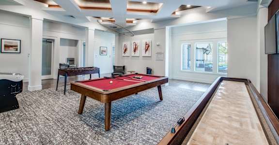 a billiards room with a red pool table