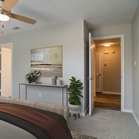 a bedroom with a bed and a ceiling fan