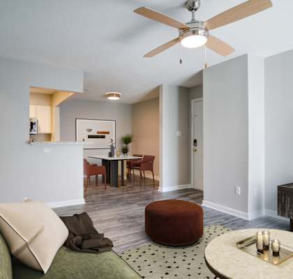 a living room with a couch and a ceiling fan