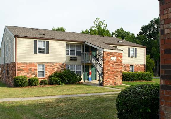 an apartment building with a person walking out of the front door