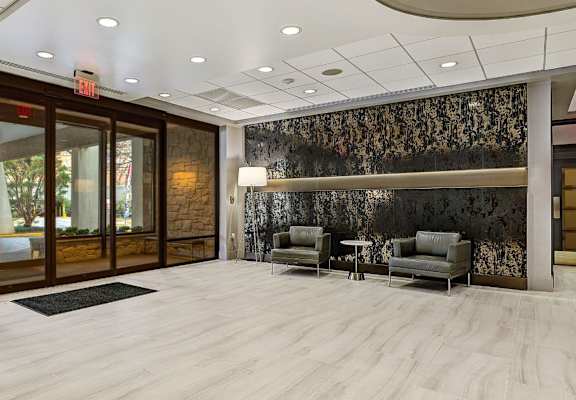 a lobby with two chairs and a table at The Ivanhoe Apartments, Hackensack, New Jersey